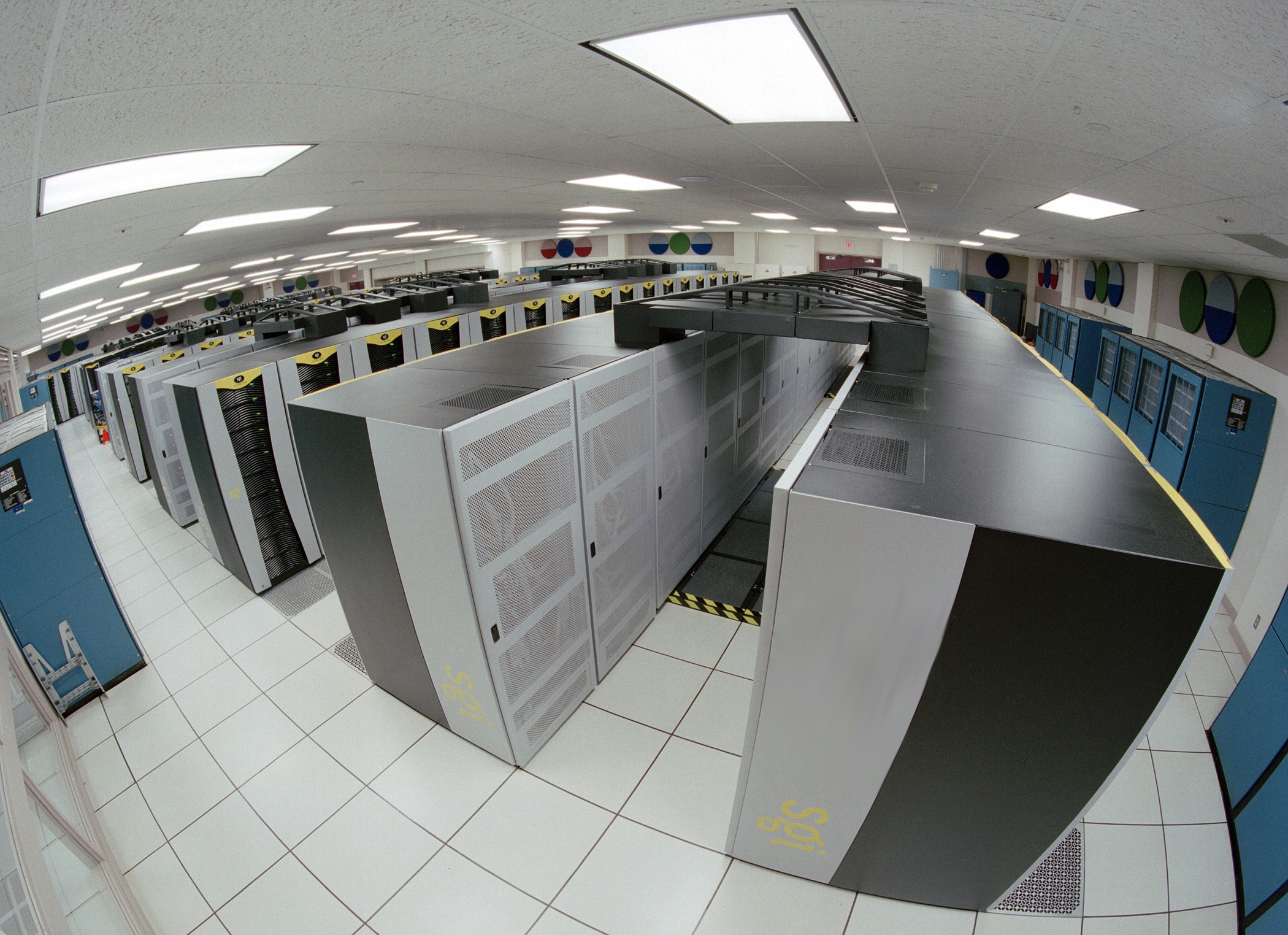 Room lined with tall server racks and equipment cabinets.